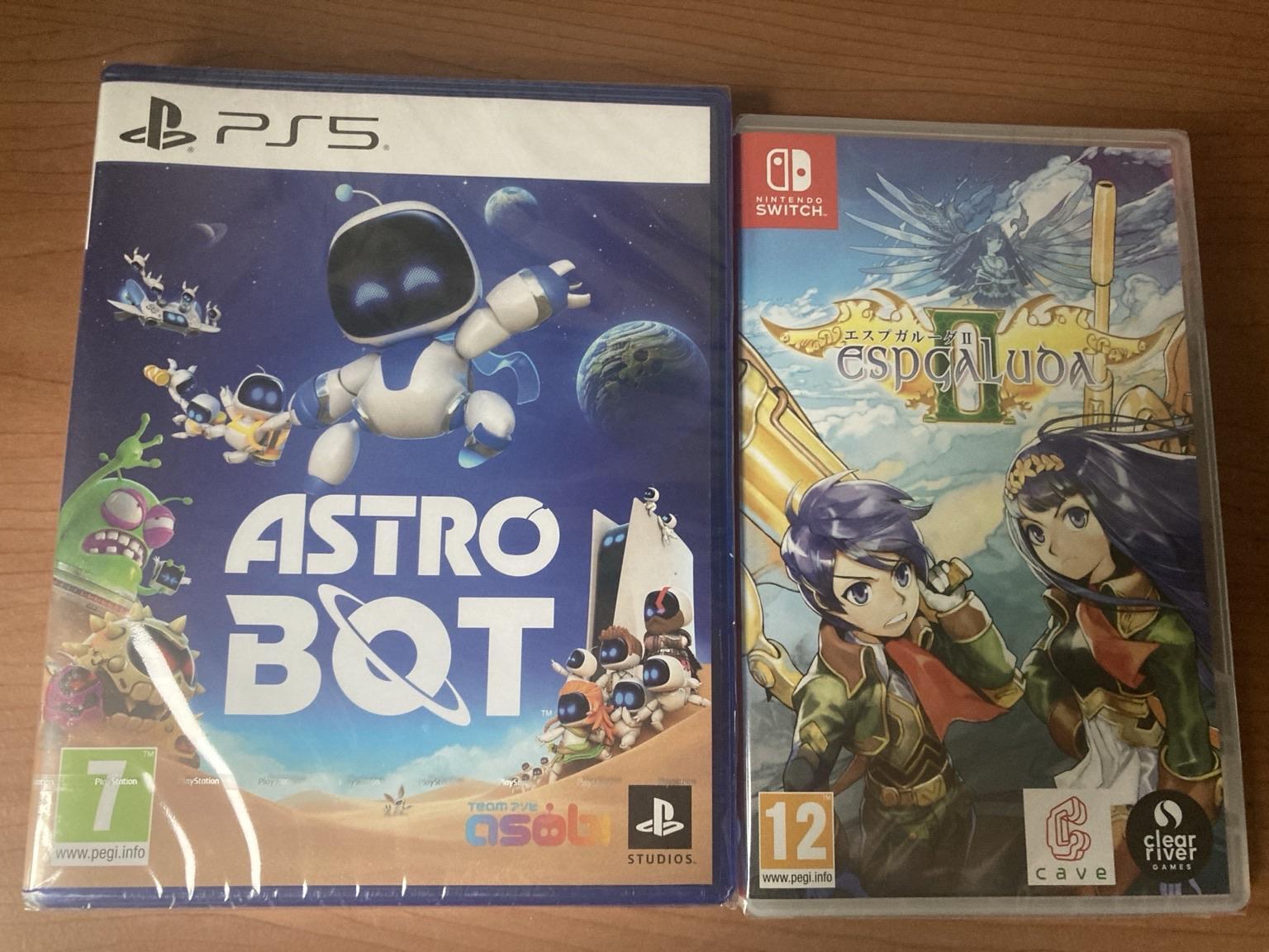 Image of two video game cases placed side by side. On the left is "Astro Bot" for PS5, featuring a colorful design with a robot character among planets and creatures. On the right is "Espgaluda II" for Nintendo Switch