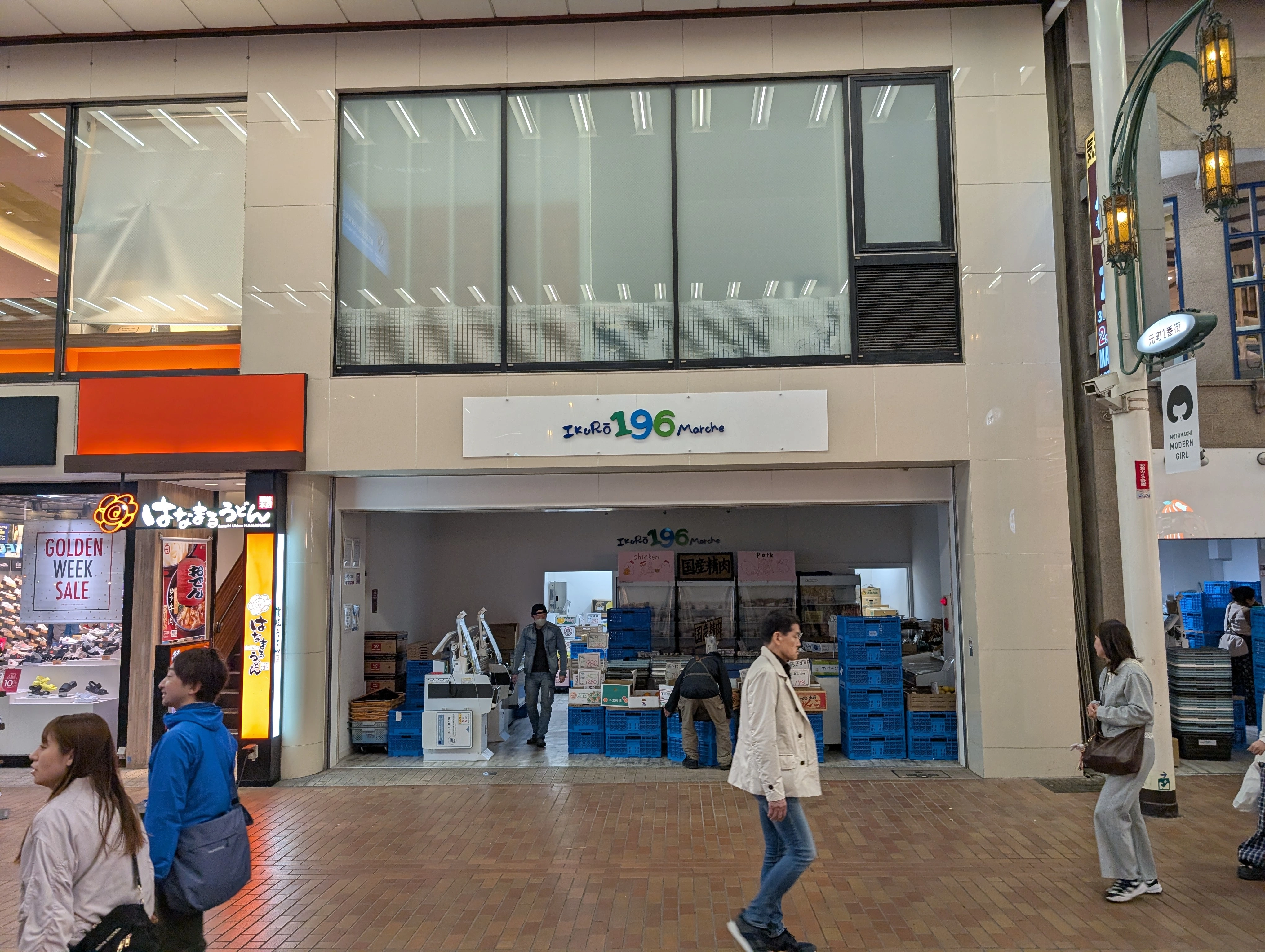 A storefront named "IkuRō 196 Marche". The 196 is written in blue and green. The store is located in a Japanese sorta shopping street thingy