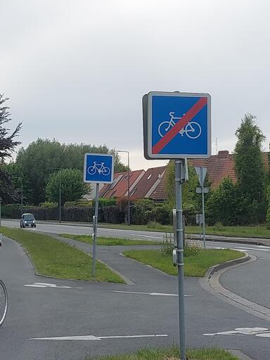 A "No biking" sign, immediately followed by a "Biking allowed" sign