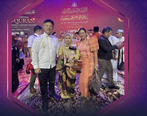 NATION’S PRIDE. NCMF Secretary Sabuddin Abdurahim (left) with Raihana Ambangala (center), a Maguindanaoan hailing from Pikit, North Cotabato, who placed second in the female recital category of the 64th International al-Qur’an Recital and Memorization Assembly in Kuala Lumpur, Malaysia, October 12, 2024. With them is Philippine Ambassador to Malaysia Maria Angela Ponce (right).

National Commission on Muslim Filipinos