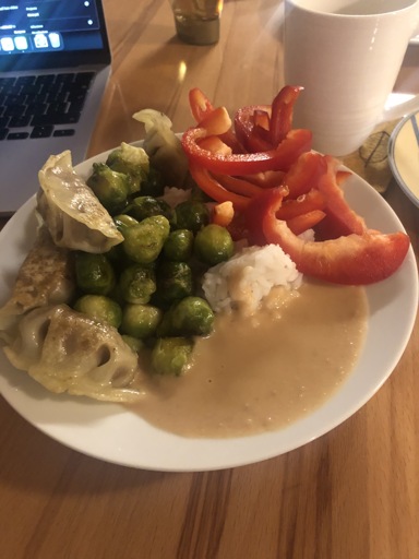Pan fried Brussel sprouts, gyoza, bell pepper and rice with peanut sauce